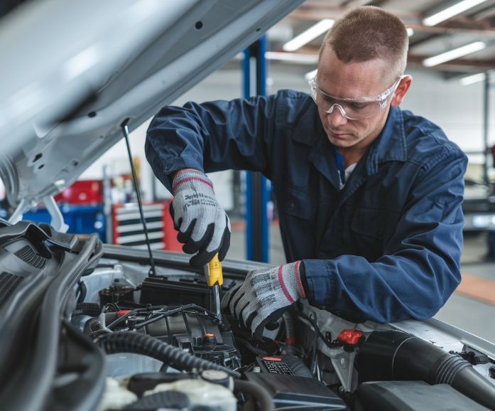 Dingmans Mechanical Technician changing Power Steering Fluid in shop Dingmans-Mechanical-Technician-changing-Power-Steering-Fluid-in-shop